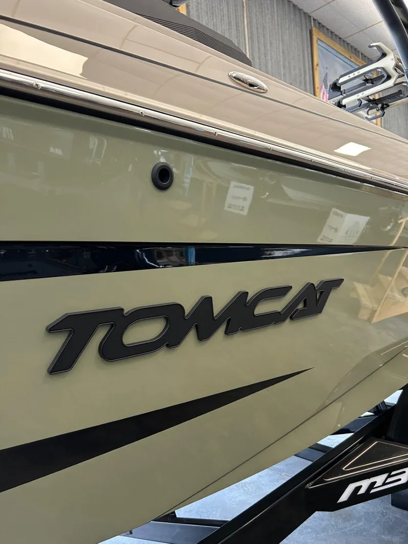Slide: The Image of 2024 MB F22 Tomcat boat side view with logo in showroom. - 1