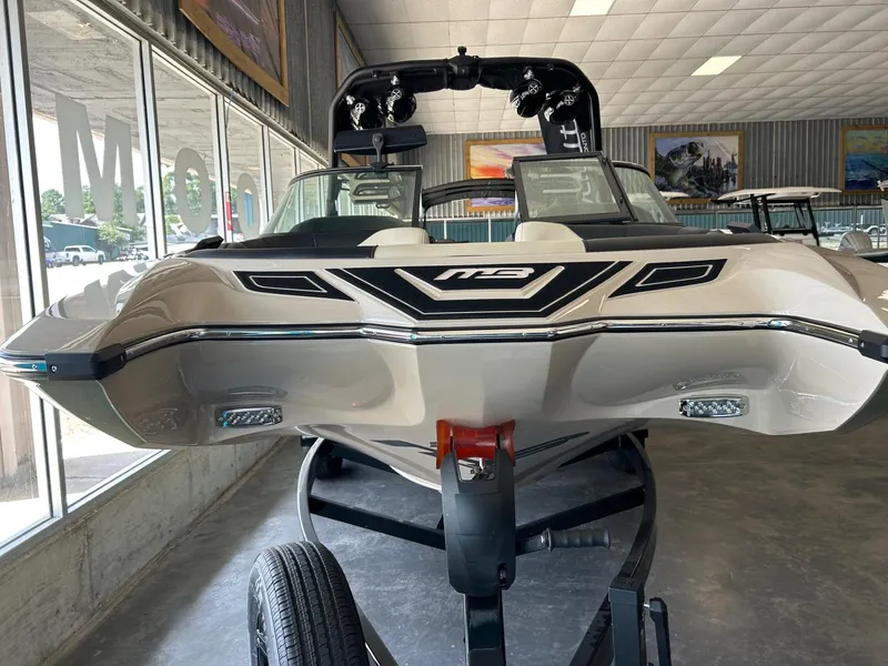 Slide: The Image of 2024 MB F22 Tomcat boat displayed indoors on a trailer. - 18