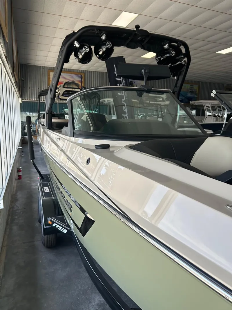 Slide: The Image of 2024 MB F22 Tomcat boat in showroom, featuring sleek design and advanced audio system. - 19