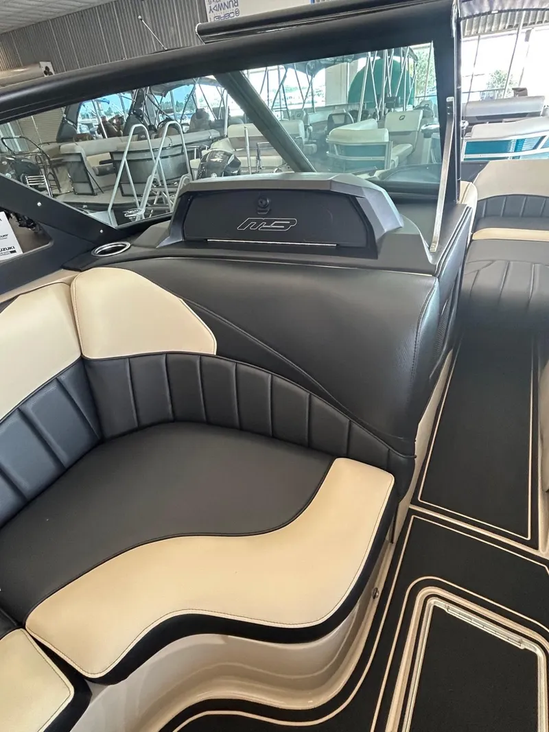 Slide: The Image of 2024 MB F22 Tomcat boat interior with black and beige seating in showroom. - 25