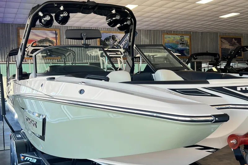 Slide: The Image of 2024 MB F22 Tomcat boat in showroom, sleek design, white exterior. - 5