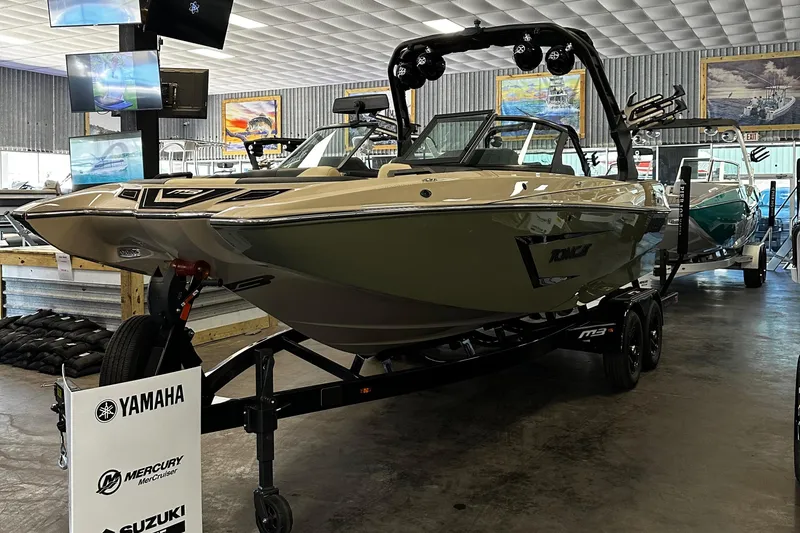 Slide: The Image of 2024 MB F22 Tomcat boat on display in showroom with Yamaha, Mercury, and Suzuki signage. - 8