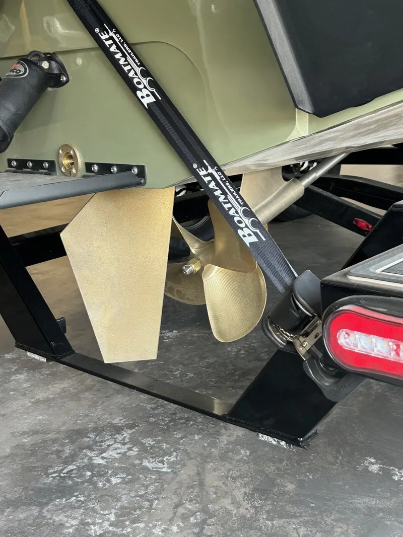 Slide: The Image of 2024 MB F22 Tomcat boat propeller and trailer detail with Boatmate strap. - 22