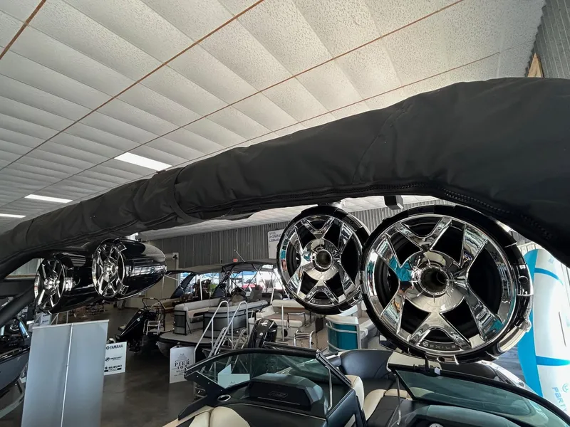 Slide: The Image of 2024 MB F22 Tomcat boat with chrome speakers in a showroom. - 3