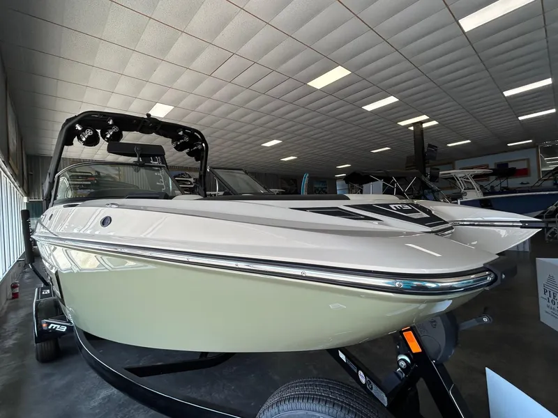 Slide: The Image of 2024 MB F22 Tomcat boat in showroom, sleek design, black and white color scheme. - 31