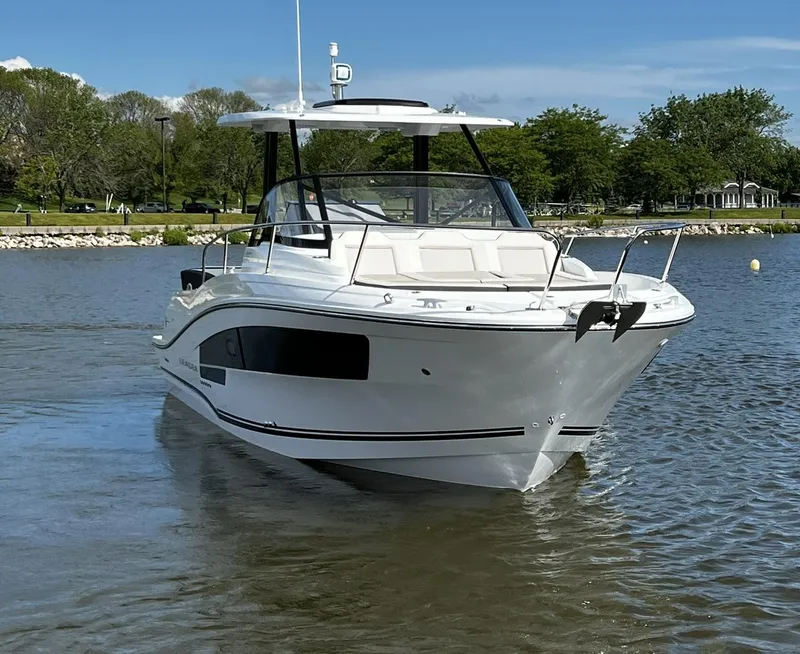 Slide: The Image of 2025 Jeanneau Leader 9.0 WA boat on calm water, scenic background. - 10