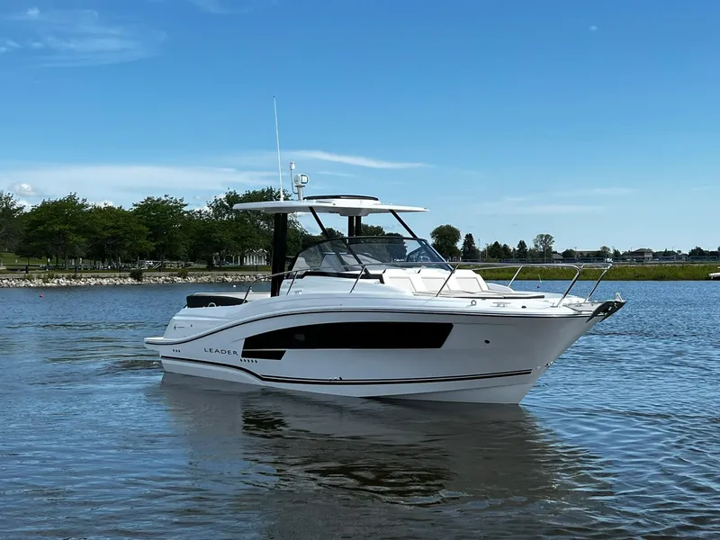 Slide: The Image of 2025 Jeanneau Leader 9.0 WA boat on calm water under clear blue sky. - 15