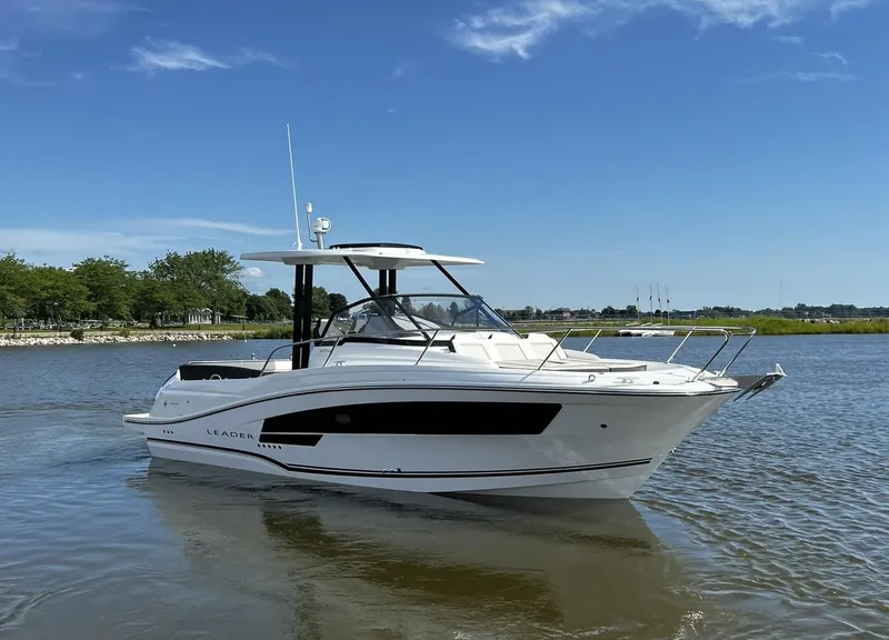 Slide: The Image of 2025 Jeanneau Leader 9.0 WA boat on calm water under clear blue sky. - 17