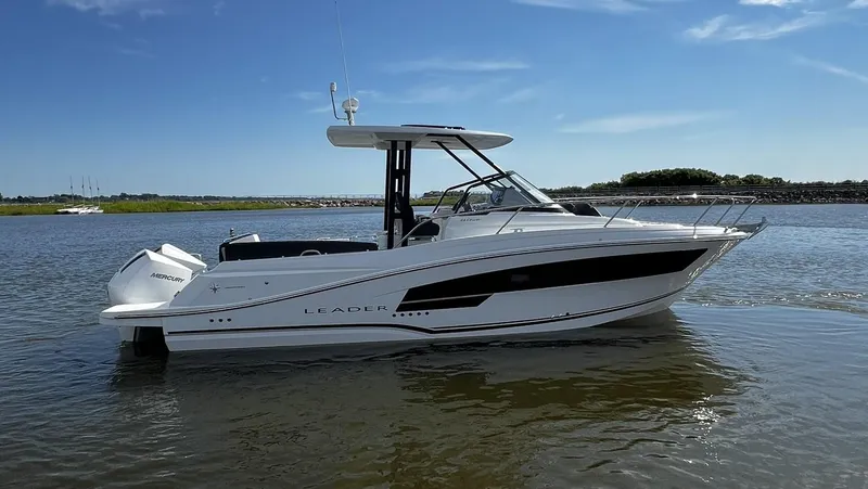 Slide: The Image of 2025 Jeanneau Leader 9.0 WA boat on calm water under clear sky. - 21