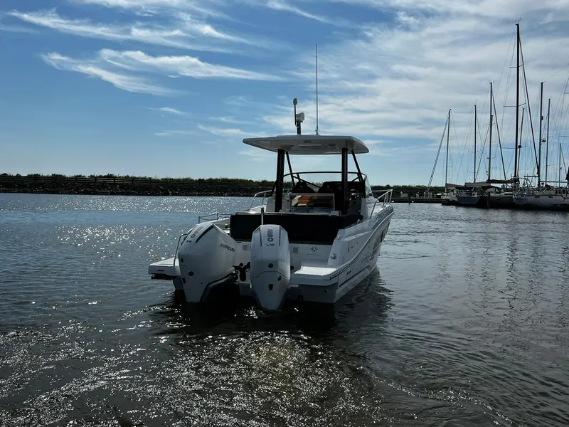 Slide: The Image of 2025 Jeanneau Leader 9.0 WA boat on calm water, clear sky background. - 22