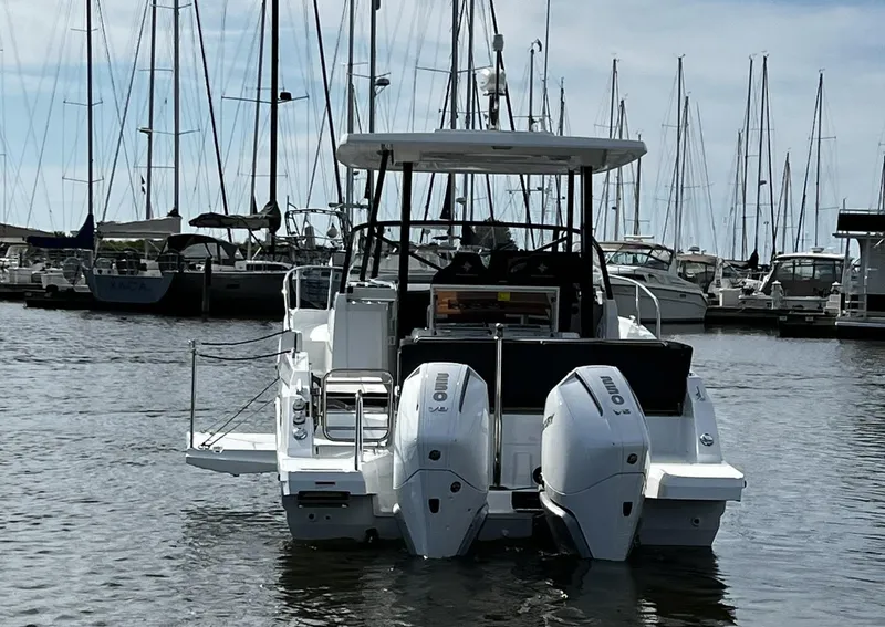 Slide: The Image of 2025 Jeanneau Leader 9.0 WA boat docked in marina with twin engines. - 23