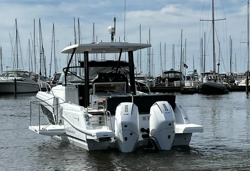 Slide: The Image of 2025 Jeanneau Leader 9.0 WA boat docked in marina with twin engines. - 24