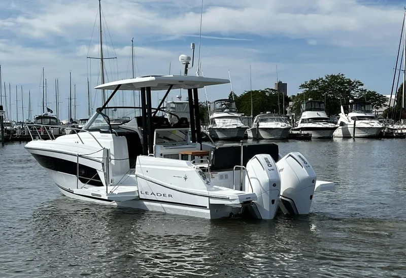 Slide: The Image of 2025 Jeanneau Leader 9.0 WA boat docked in marina with twin engines. - 26