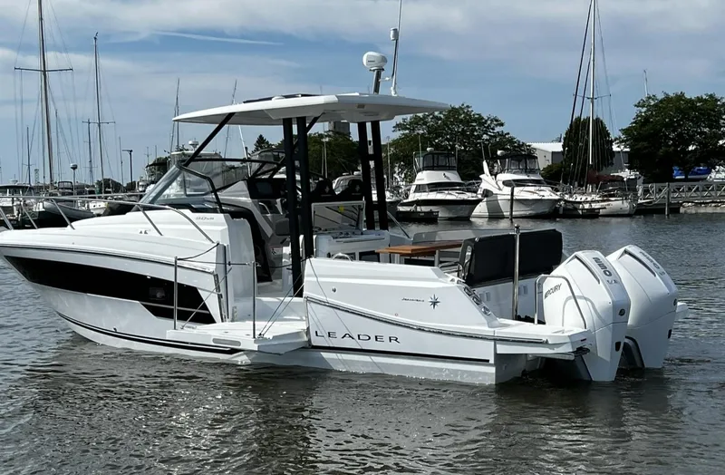 Slide: The Image of 2025 Jeanneau Leader 9.0 WA boat docked in marina, featuring twin engines. - 27