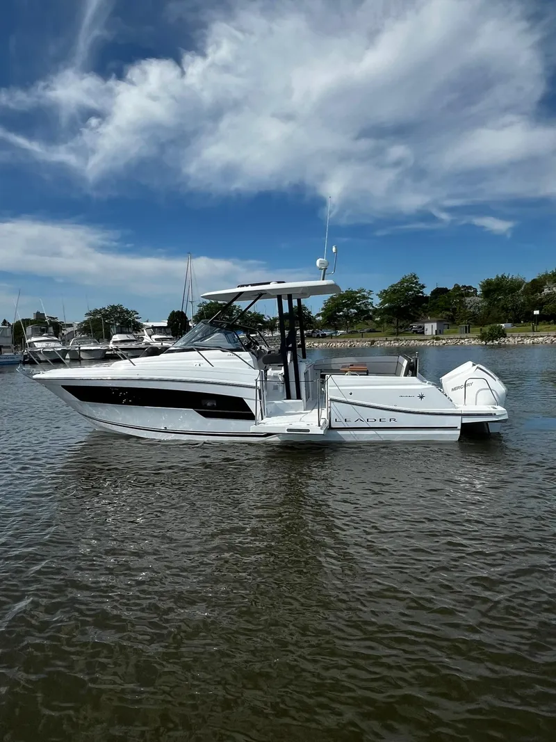 Slide: The Image of 2025 Jeanneau Leader 9.0 WA boat on calm water under a blue sky. - 28