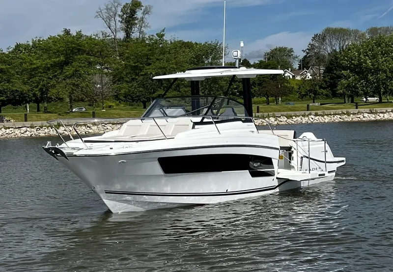 Slide: The Image of 2025 Jeanneau Leader 9.0 WA boat on a calm lake with trees in the background. - 3
