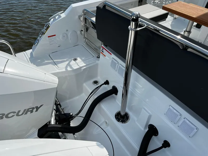 Slide: The Image of 2025 Jeanneau Leader 9.0 WA boat deck with Mercury engine, sleek design. - 31