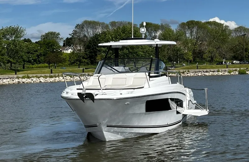 Slide: The Image of 2025 Jeanneau Leader 9.0 WA boat cruising on a calm lake with scenic background. - 4