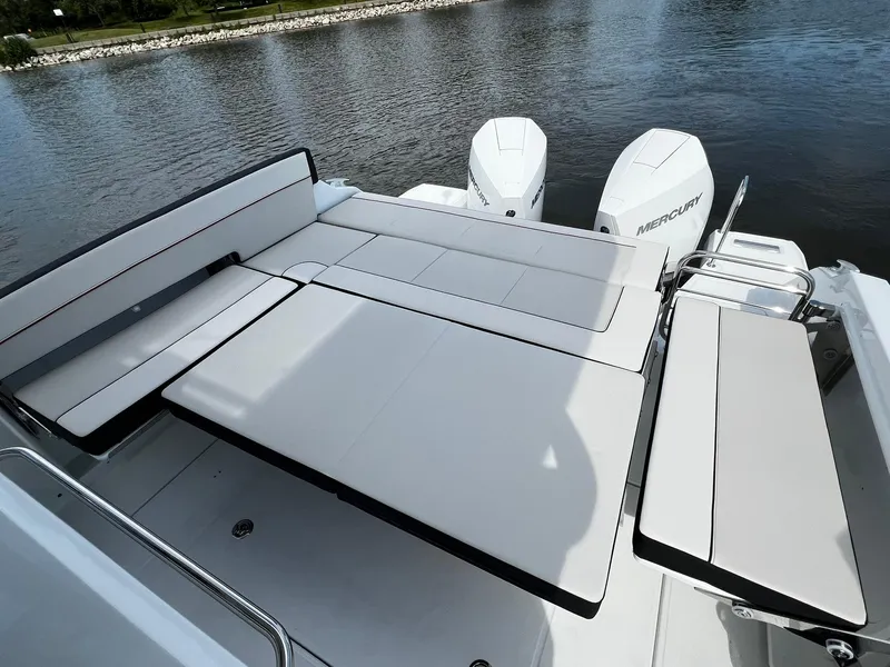 Slide: The Image of 2025 Jeanneau Leader 9.0 WA boat with spacious sun deck and twin Mercury engines. - 42