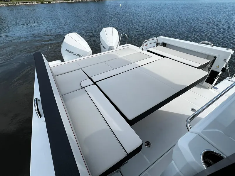 Slide: The Image of 2025 Jeanneau Leader 9.0 WA boat with spacious sunbathing deck and twin Mercury engines. - 43