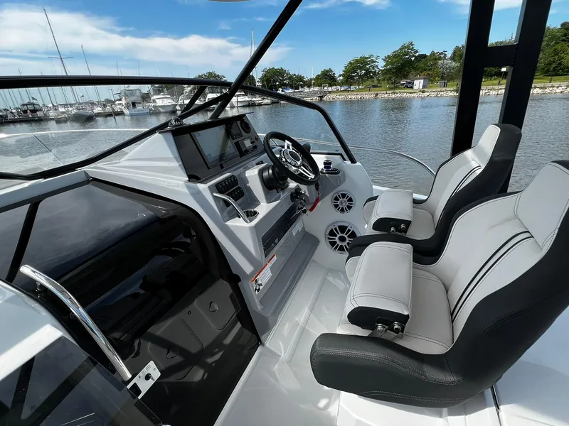 Slide: The Image of 2025 Jeanneau Leader 9.0 WA boat cockpit with modern controls and seating. - 44
