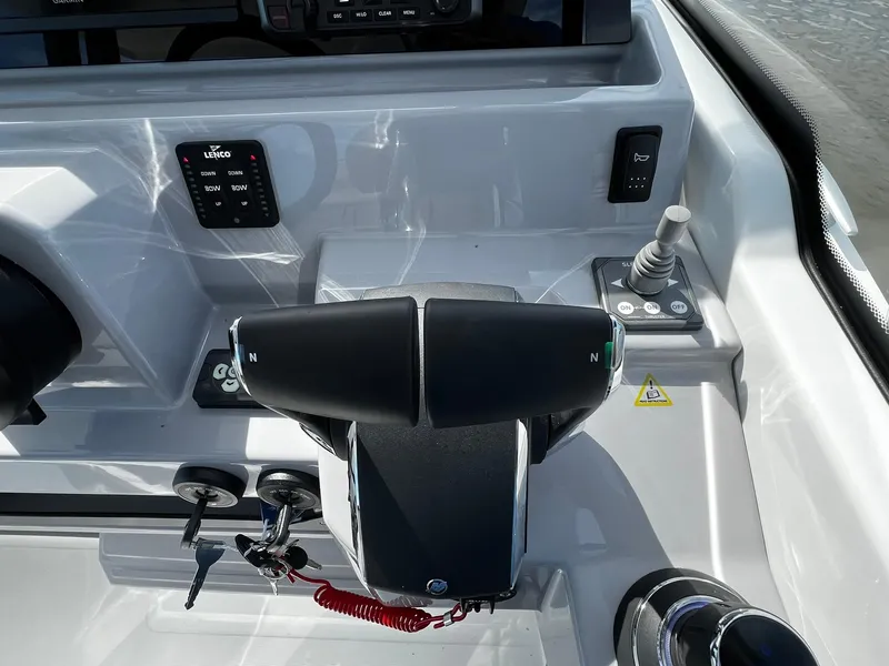 Slide: The Image of 2025 Jeanneau Leader 9.0 WA boat controls with modern dashboard and throttle. - 47