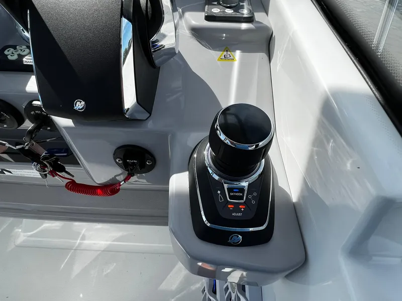 Slide: The Image of 2025 Jeanneau Leader 9.0 WA boat control panel with joystick and safety features. - 48