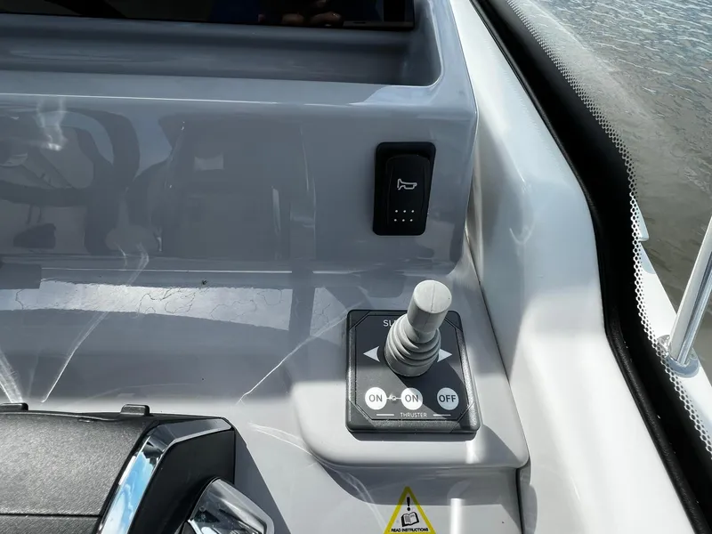Slide: The Image of Control panel of 2025 Jeanneau Leader 9.0 WA boat with joystick and switches. - 49
