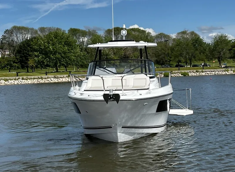 Slide: The Image of 2025 Jeanneau Leader 9.0 WA boat on a calm lake with trees in the background. - 5