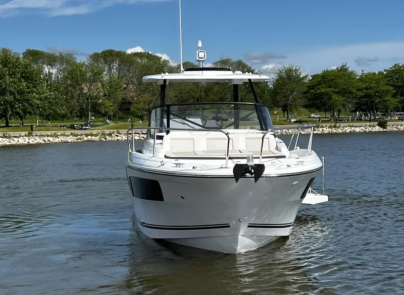 Slide: The Image of 2025 Jeanneau Leader 9.0 WA boat cruising on a calm lake with trees in the background. - 7