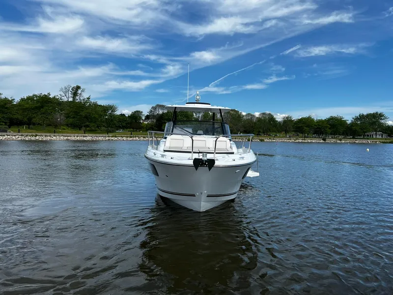 Slide: The Image of 2025 Jeanneau Leader 9.0 WA boat on calm water under a blue sky. - 9