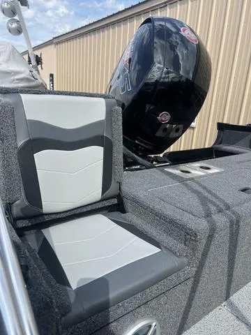 Slide: The Image of 2022 Lowe FS18 boat with cushioned seating and powerful outboard motor. - 10