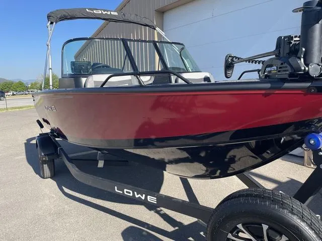 Slide: The Image of 2022 Lowe FS18 boat with red and black exterior on a trailer. - 2