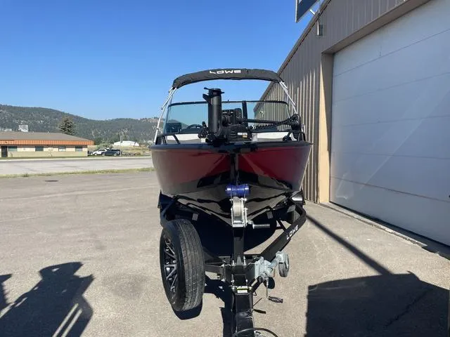 Slide: The Image of 2022 Lowe FS18 boat on trailer outside a garage. - 3