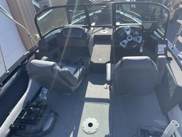 Slide: The Image of 2022 Lowe FS18 boat interior with dual seats and steering console. - 7
