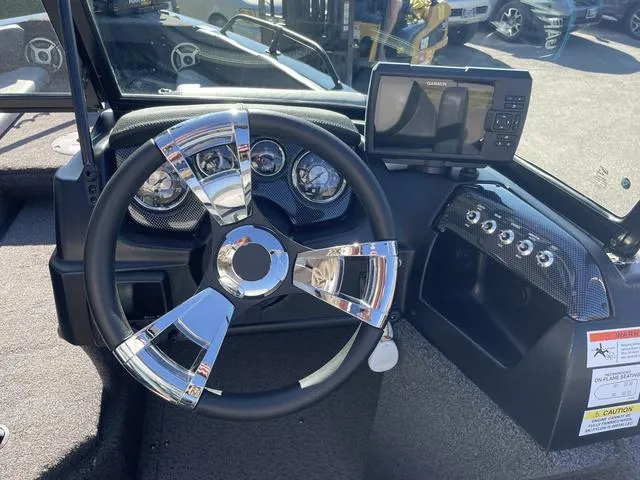 Slide: The Image of 2022 Lowe FS18 boat dashboard with steering wheel and Garmin GPS. - 8