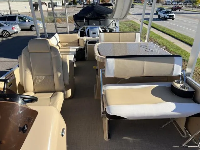 Slide: The Image of 2023 Avalon Catalina Entertainer Funship 25 FT interior with beige seating and table. - 4