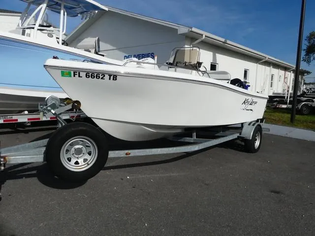 Slide: The Image of 2021 Key Largo 1800C boat on a trailer in a parking lot. - 1