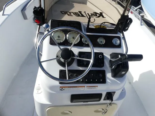 Slide: The Image of 2021 Key Largo 1800C boat dashboard with steering wheel and gauges. - 10