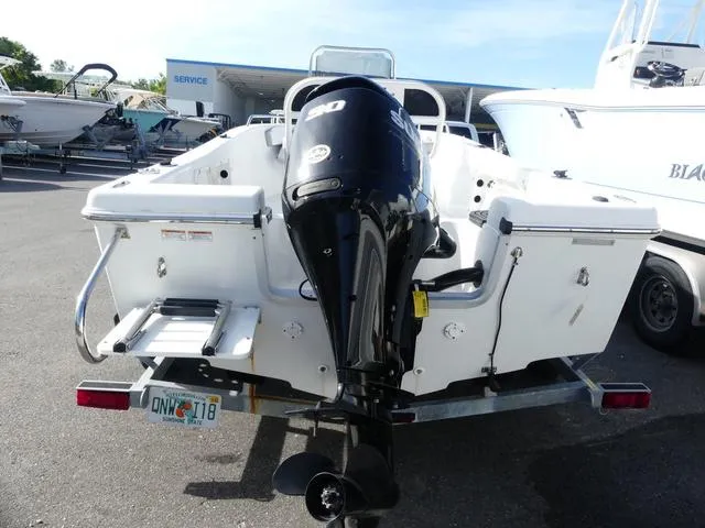 Slide: The Image of 2021 Key Largo 1800C boat with 90 HP outboard motor, docked at marina. - 7
