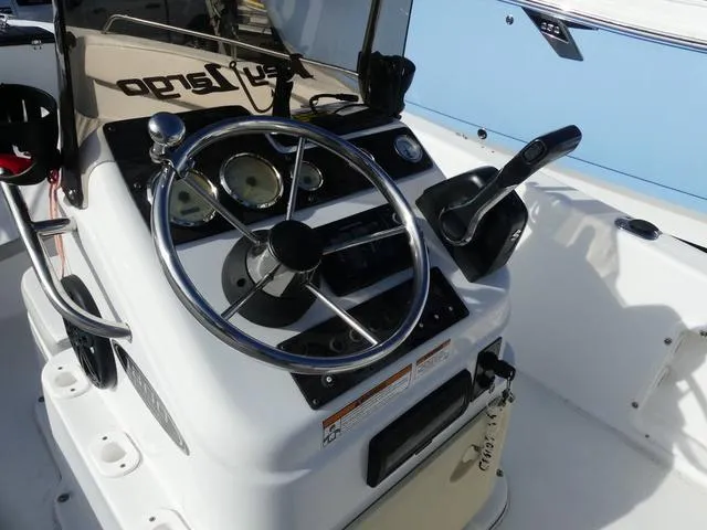 Slide: The Image of 2021 Key Largo 1800C boat dashboard with steering wheel and control panel. - 9