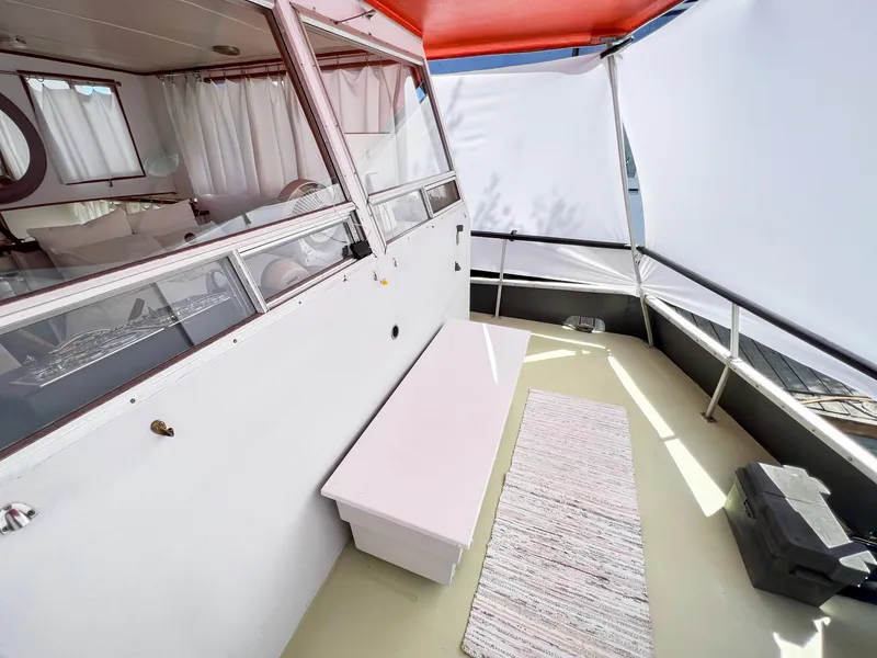 Slide: The Image of 1970 Tollycraft Tollyhome 36 boat deck with seating, rug, and canopy. - 10