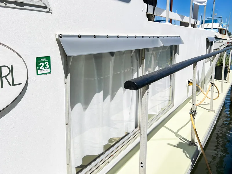 Slide: The Image of 1970 Tollycraft Tollyhome 36 boat with window awnings and docked at marina. - 15