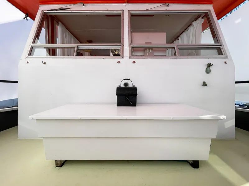 Slide: The Image of 1970 Tollycraft Tollyhome 36 boat interior with white seating and red canopy. - 16