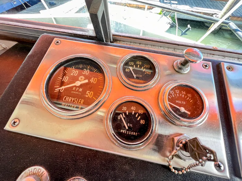 Slide: The Image of 1970 Tollycraft Tollyhome 36 dashboard with Chrysler RPM, temperature, volts, and oil pressure gauges. - 25