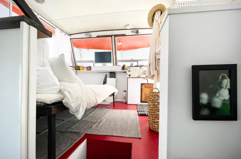 Slide: The Image of 1970 Tollycraft Tollyhome 36 interior with modern decor, featuring white and red accents. - 26