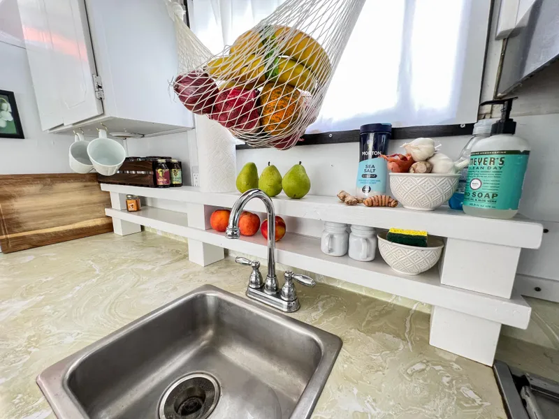 Slide: The Image of 1970 Tollycraft Tollyhome 36 kitchen with fruit hammock, sink, and countertop essentials. - 31