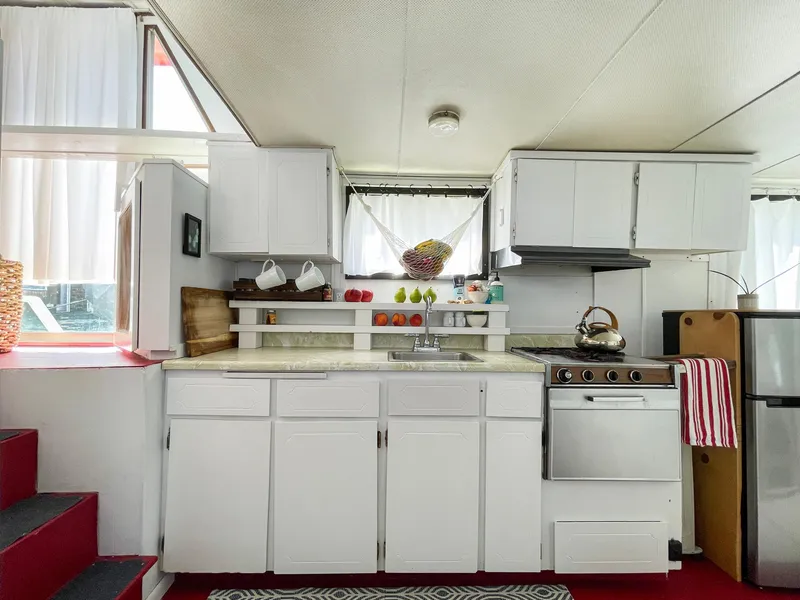 Slide: The Image of 1970 Tollycraft Tollyhome 36 kitchen with white cabinets and compact appliances. - 33