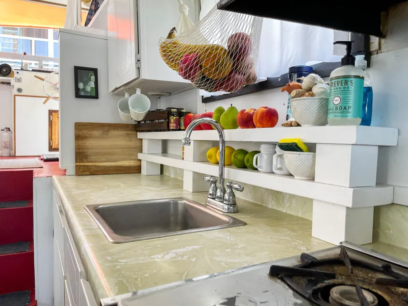 Slide: The Image of 1970 Tollycraft Tollyhome 36 kitchen with sink, fruit, and soap on counter. - 36