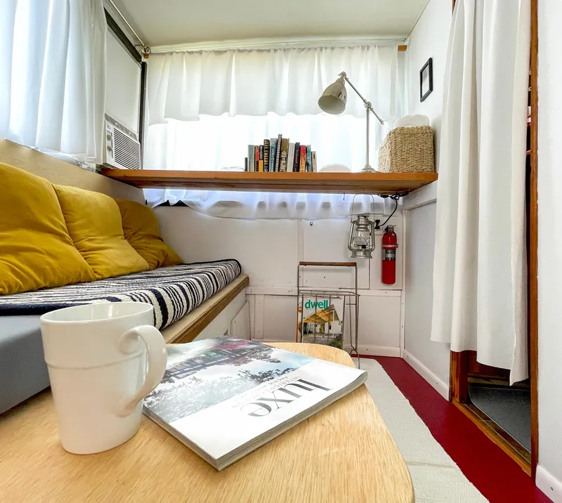 Slide: The Image of 1970 Tollycraft Tollyhome 36 interior with cozy seating, books, and decor. - 40